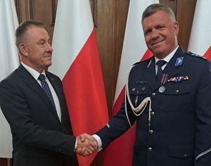 Komendant inspektor Marcin Grzelak odbiera medal i gratulacje od Wojewody Łódzkiego Karola Młynarczyka.