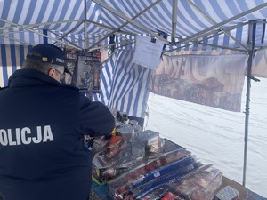 Policjant kontrolujący stoisko z fajerwerkami.