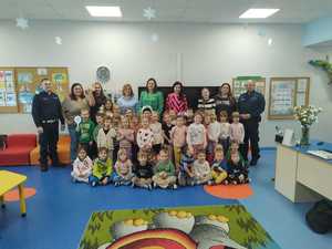 Policjanci wraz z grupą dzieci i nauczycieli.