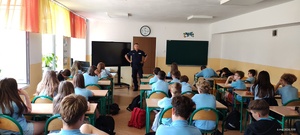 Dzielnicowy rozmawiający o hejcie z dziećmi z 6 klasy Szkoły Podstawowej nr 1 w Brzezinach.